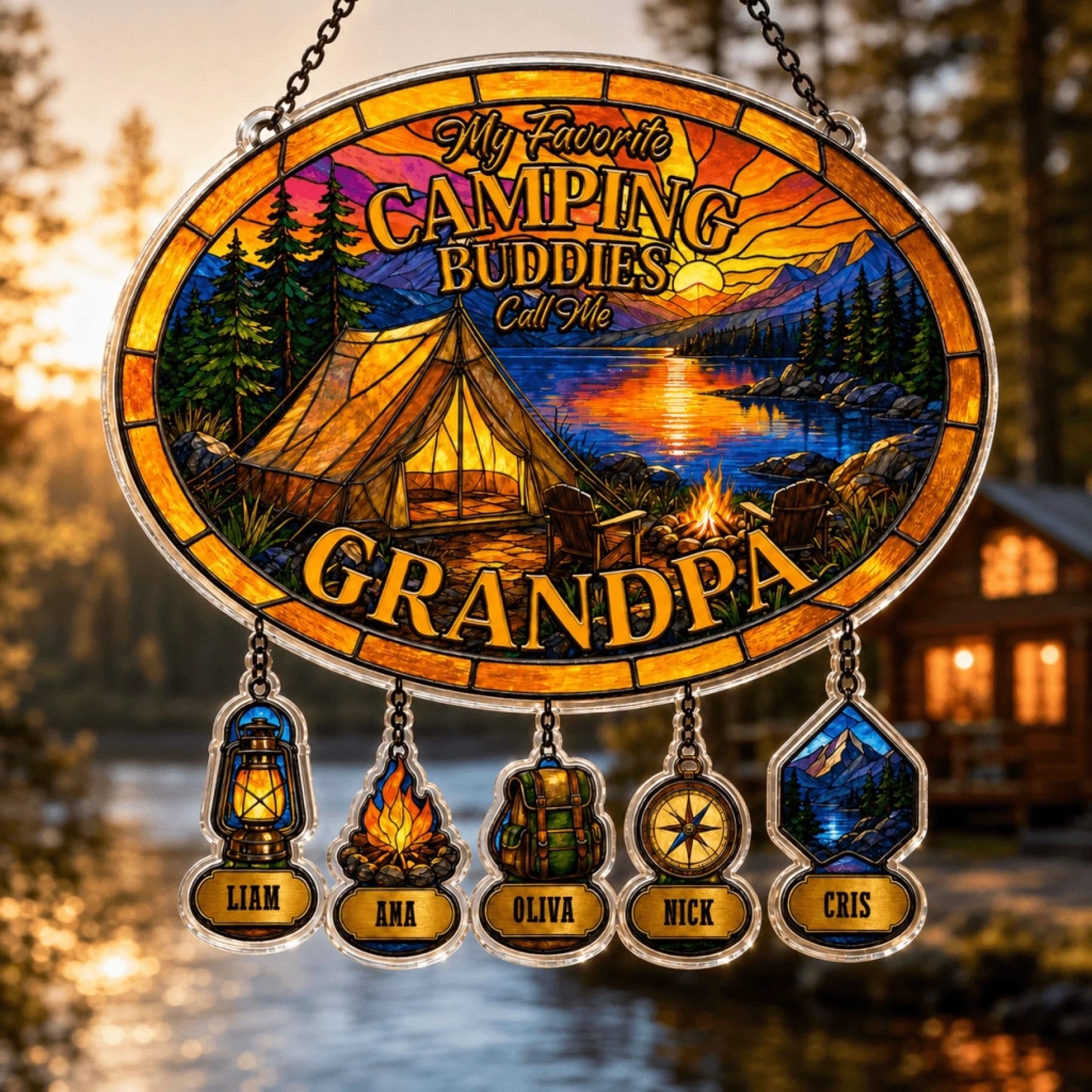 Decorative stained glass panel with camping design and names of children, set against a blurred forest and cabin background.