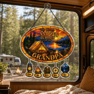 Decorative sign with camping theme hanging inside a vehicle, showing a scenic view of a lake and trees.