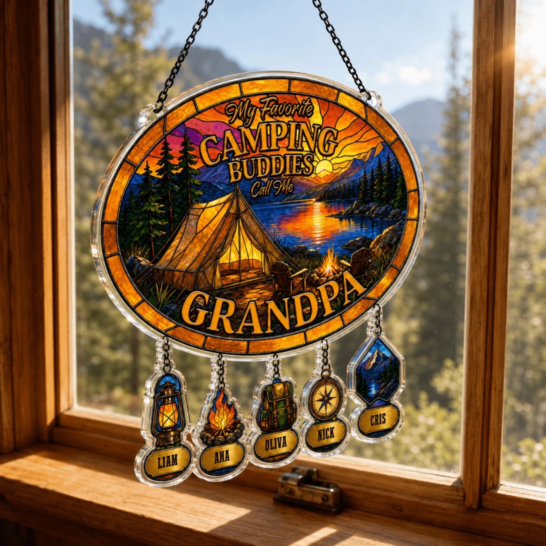 Decorative sign with camping theme and names hanging on a window