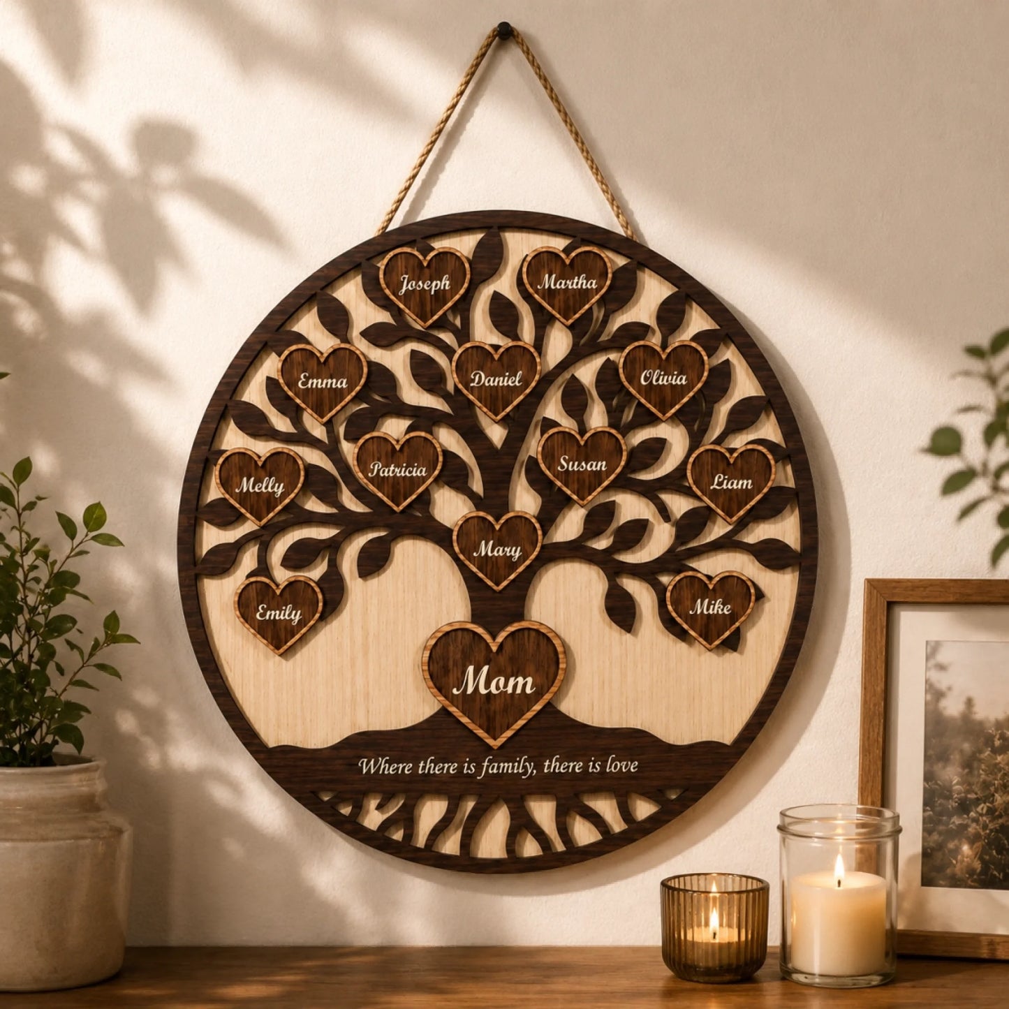 Wooden family tree wall decor with engraved names, hanging on a wall with candles and a plant.