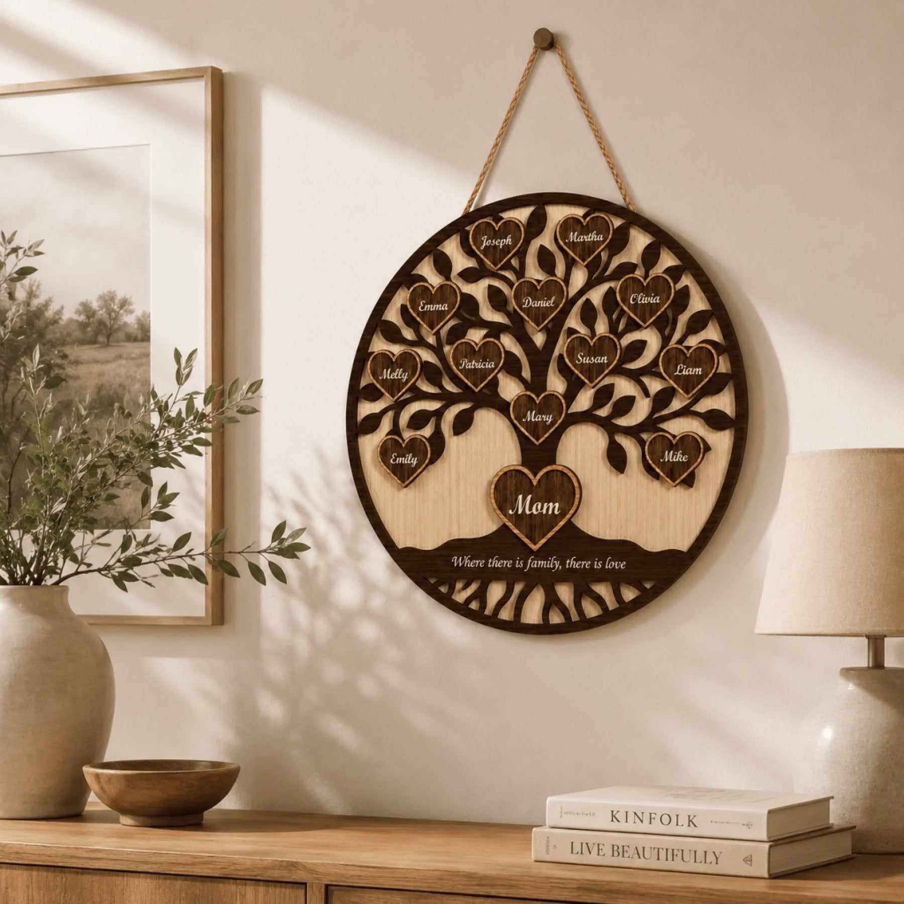 Wooden family tree wall decor hanging on a wall with books and a lamp in the background.