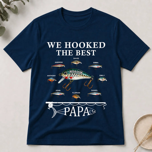 Navy blue t-shirt with fishing-themed design and text on a light background