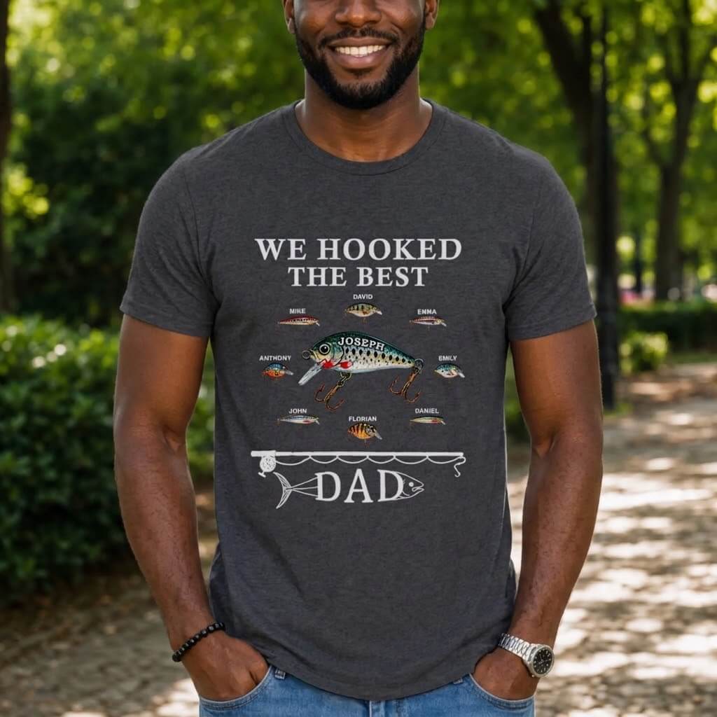 Man wearing a t-shirt with a fishing graphic and text outdoors.