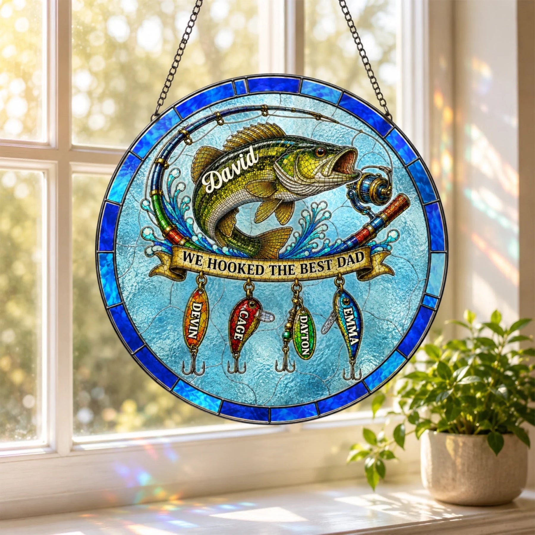 Stained glass panel with fish and fishing lures on a window sill