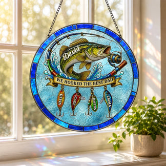 Stained glass panel with fish and fishing lures on a window sill