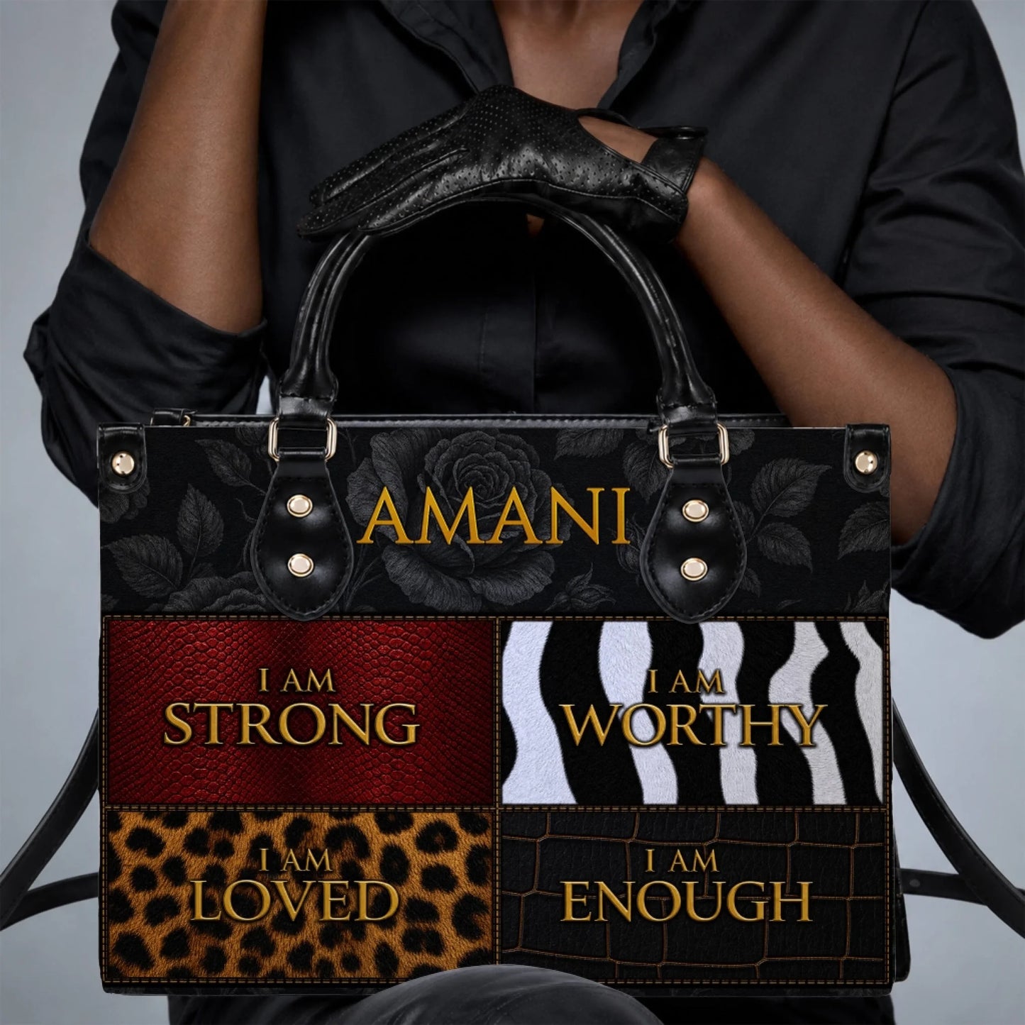 A woman holding a personalized Amani handbag with motivational affirmations and a unique animal print patchwork design.