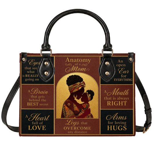 Anatomy of a Mom shoulder bag featuring an artistic illustration of an African American mother and child illustration.