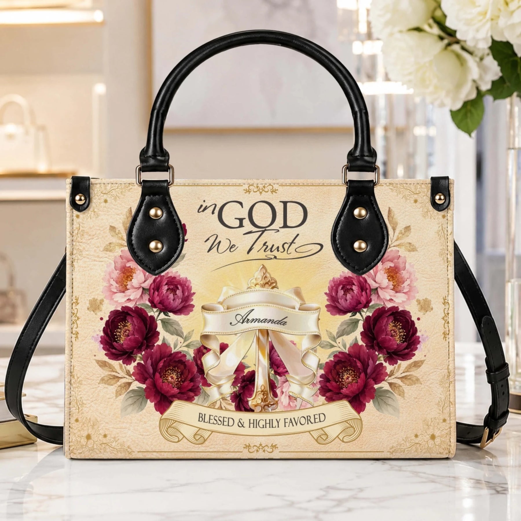 Stylish custom name handbag featuring religious floral design for Armanda, displayed on a clean marble surface.