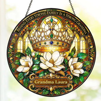 A decorative circular suncatcher with a royal crown and magnolia design personalized with the name Grandma Laura.