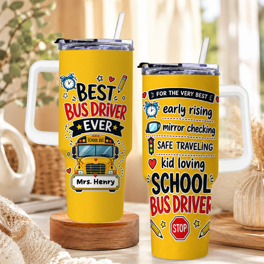 Two yellow tumblers with white handles and straws. One says "BEST BUS DRIVER EVER" with a school bus and "Mrs. Henry"; the other lists bus driver traits.
