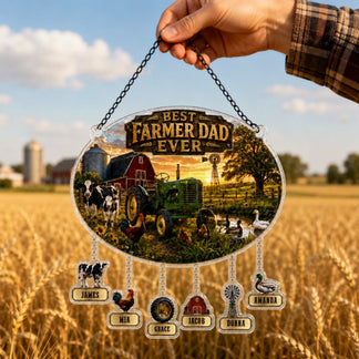 Hanging plaque with 'Best Farmer Dad Ever' text and farm-themed design, held over a rural landscape.