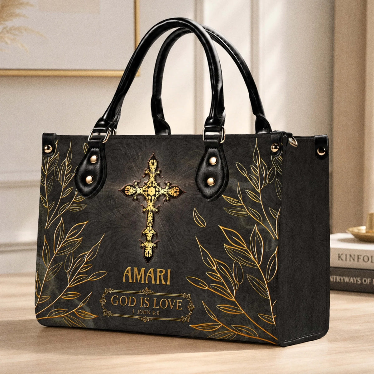 A personalized religious themed handbag with gold leaf accents a golden cross and the inscription God is Love 1 John 4:8.