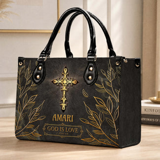 A personalized religious themed handbag with gold leaf accents a golden cross and the inscription God is Love 1 John 4:8.