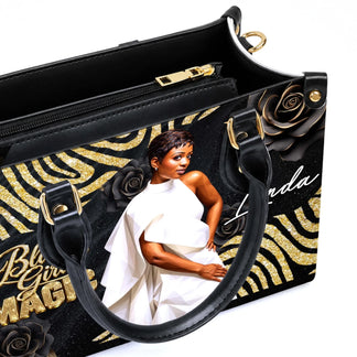 Close up of personalized Black Girl Magic handbag showing the zipper, interior compartment, and elegant custom art.
