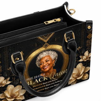 Black leather tote bag featuring a portrait of an elegant woman with the quote She Is Our Black Queen and floral art.
