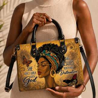 A stylish handbag held by a woman, showcasing a Black woman portrait with butterflies and religious inspirational text.