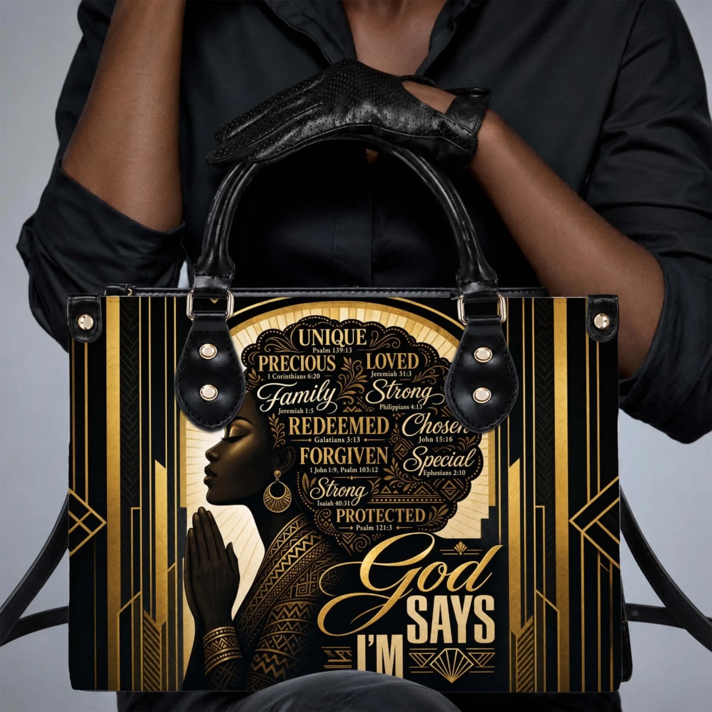 Woman holding a black and gold handbag with a faith inspired graphic of a praying woman and motivational text.