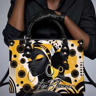 Fashion handbag featuring artistic black woman portraits and motivational words like fearless kind and powerful in yellow