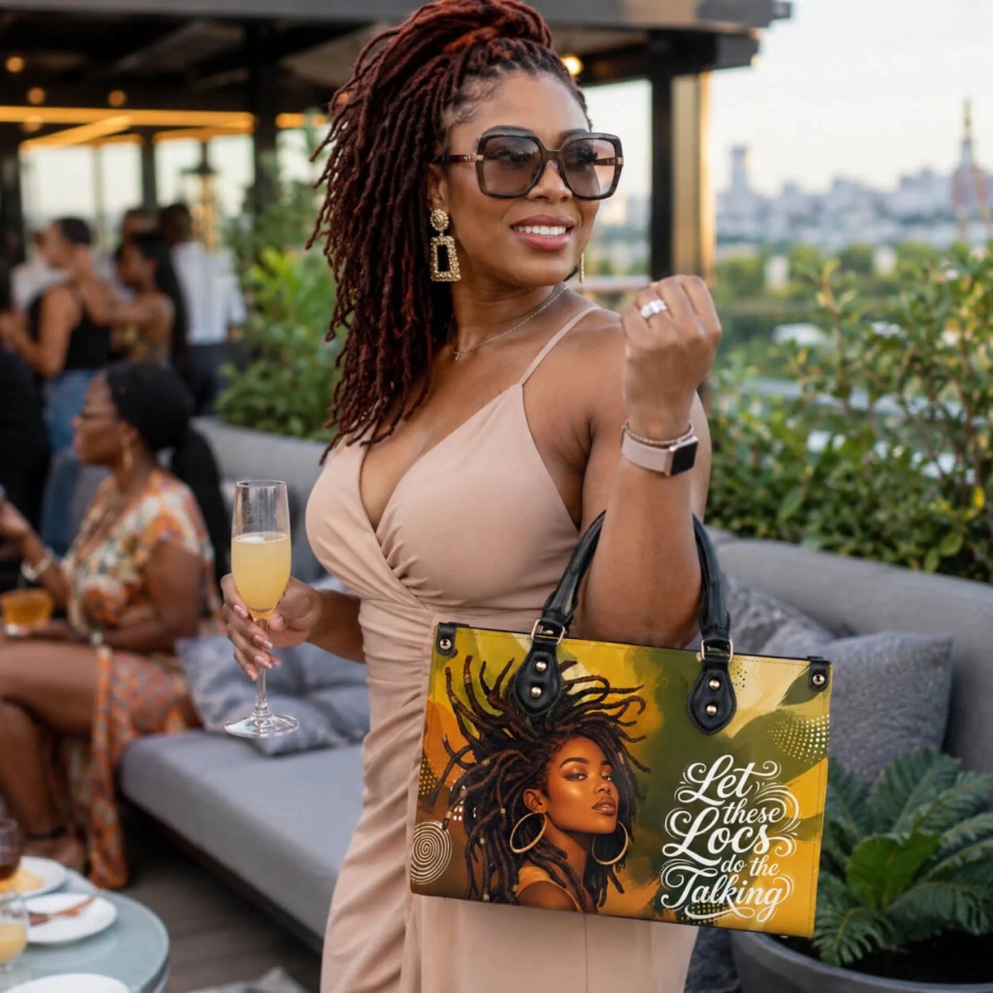 A woman holding a personalized PU leather handbag with an African American locs hair design while enjoying a celebration.