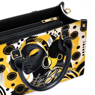 Close up of an interior view of a stylish black woman art handbag with zipper closure and artistic yellow and black design