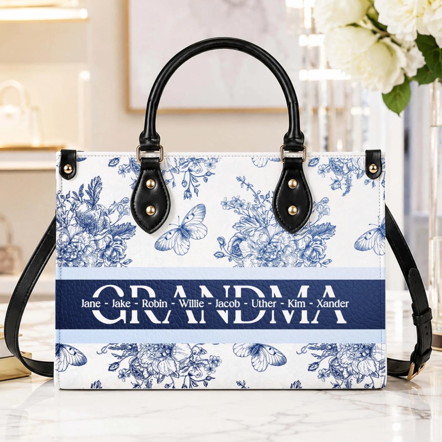 Elegant blue and white floral patterned handbag customized with the word grandma and a list of grandchildren names