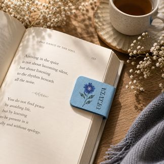 Close up of a blue floral magnetic bookmark personalized with the name Olivia, perfect for book lovers and readers.