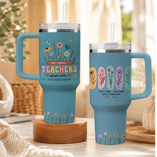 Set of two light blue stainless steel tumblers with straw for teachers, featuring flower garden and quote graphics.