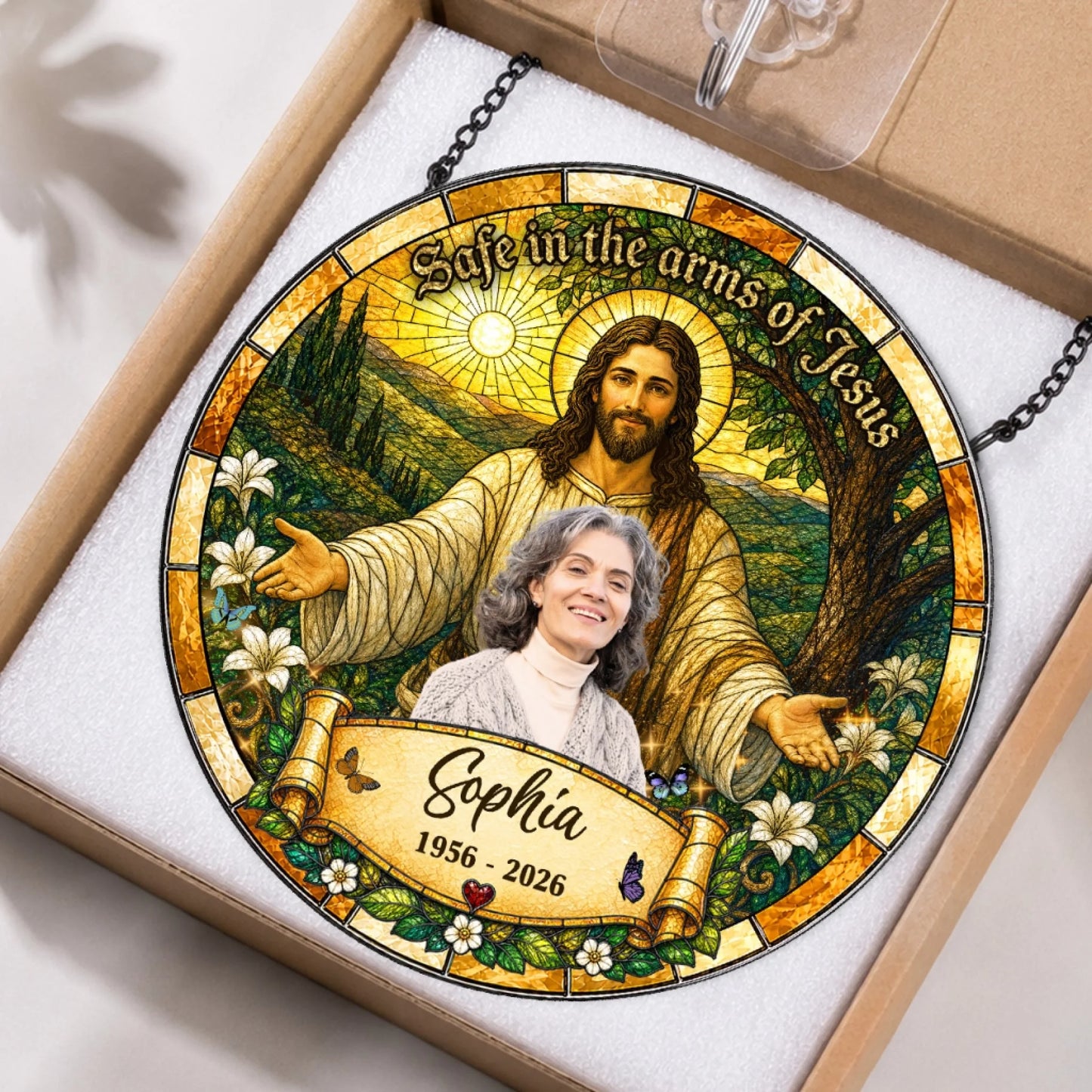 Personalized memorial stained glass ornament featuring Jesus and Sophia, neatly packaged in a protective gift box.