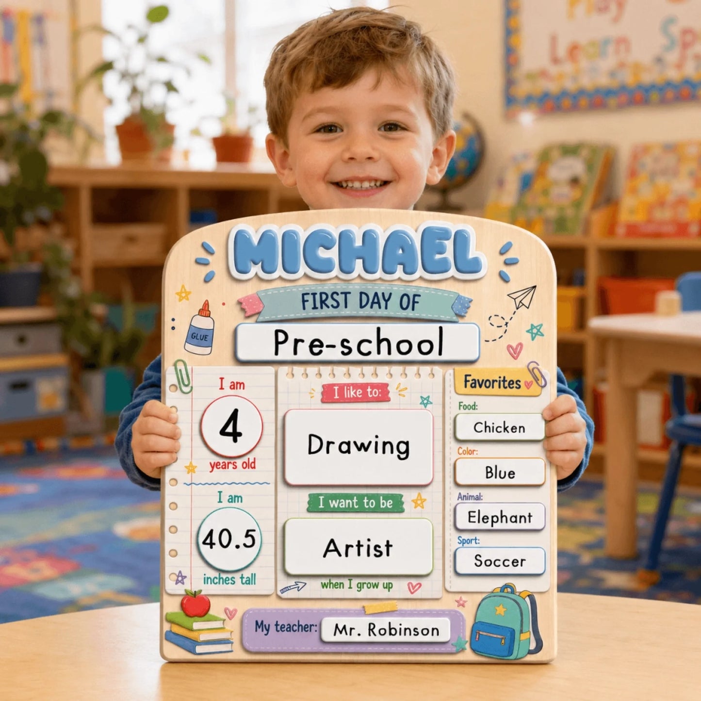 Happy preschool boy holding a custom wooden back to school board with his name, age, interests, and teacher details.