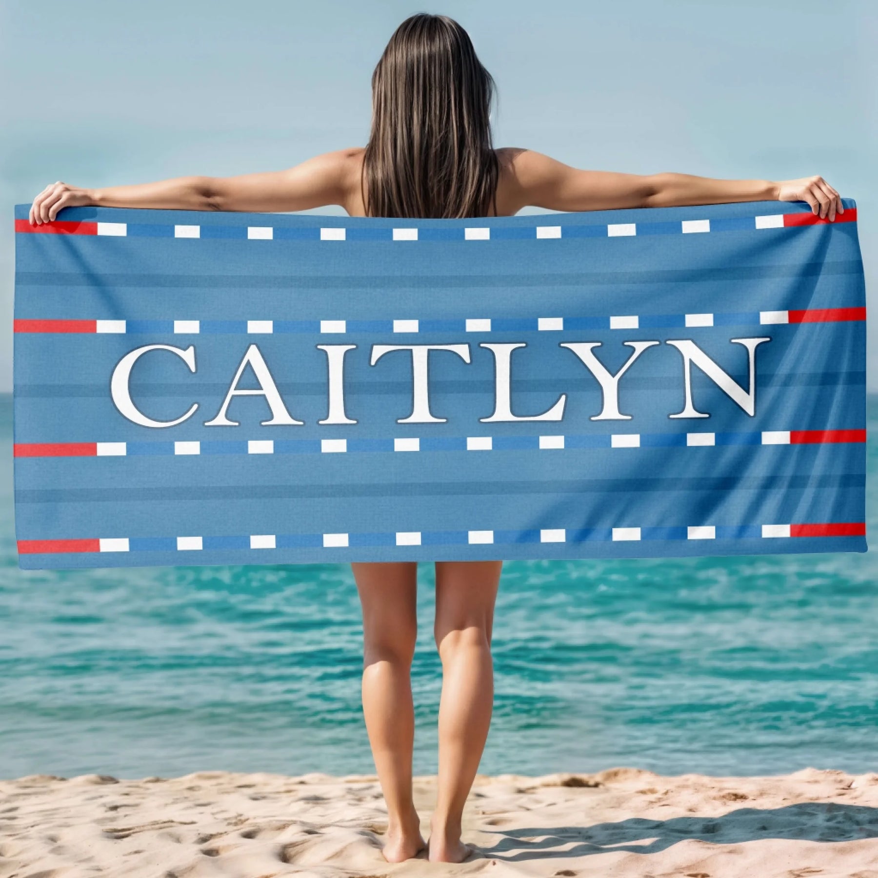Custom swimming theme beach towel with a lane marker design and the name Caitlyn in elegant white capital letters.