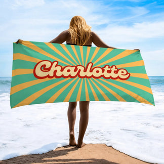 Personalized Charlotte beach towel featuring a vintage yellow and teal sunburst pattern for summer vacation gifts.