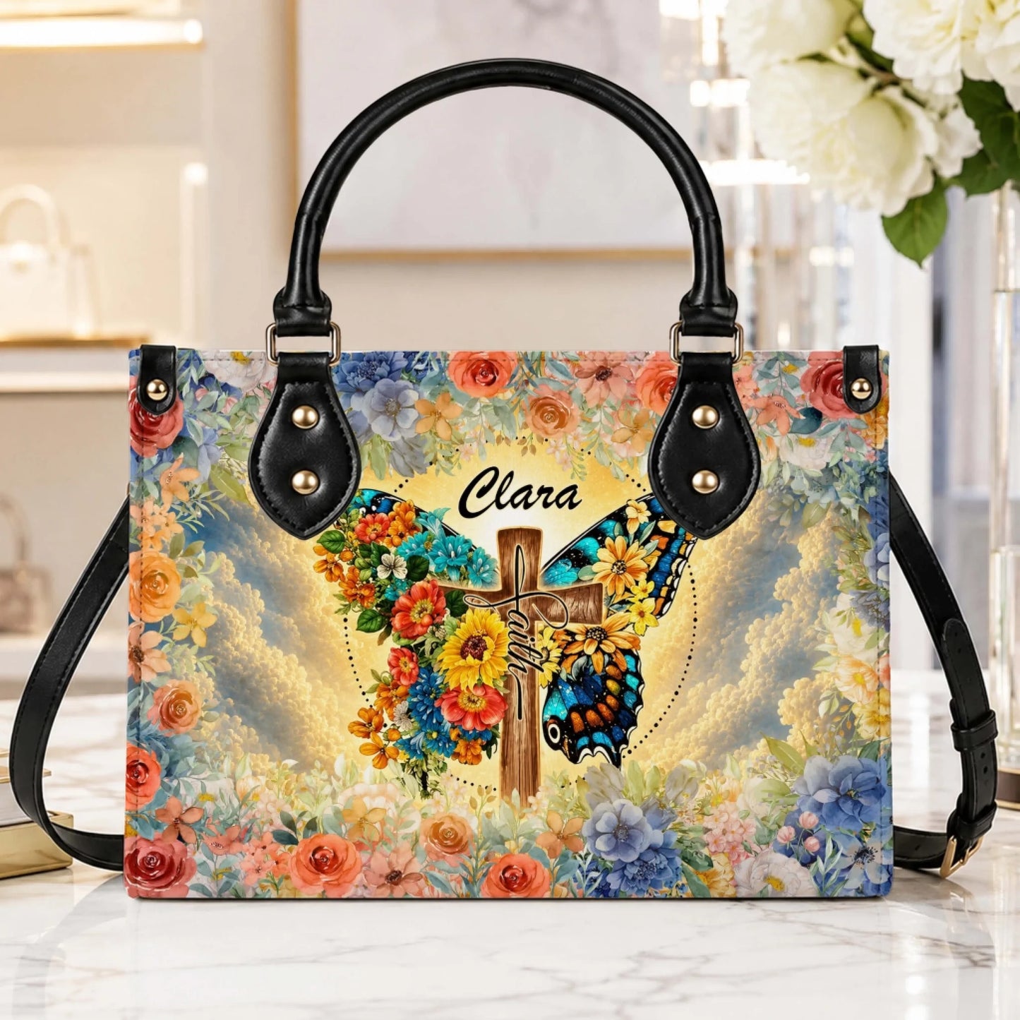 Personalized handbag with a butterfly and cross design, featuring floral accents and the custom name Clara, perfect as a sympathy gift.