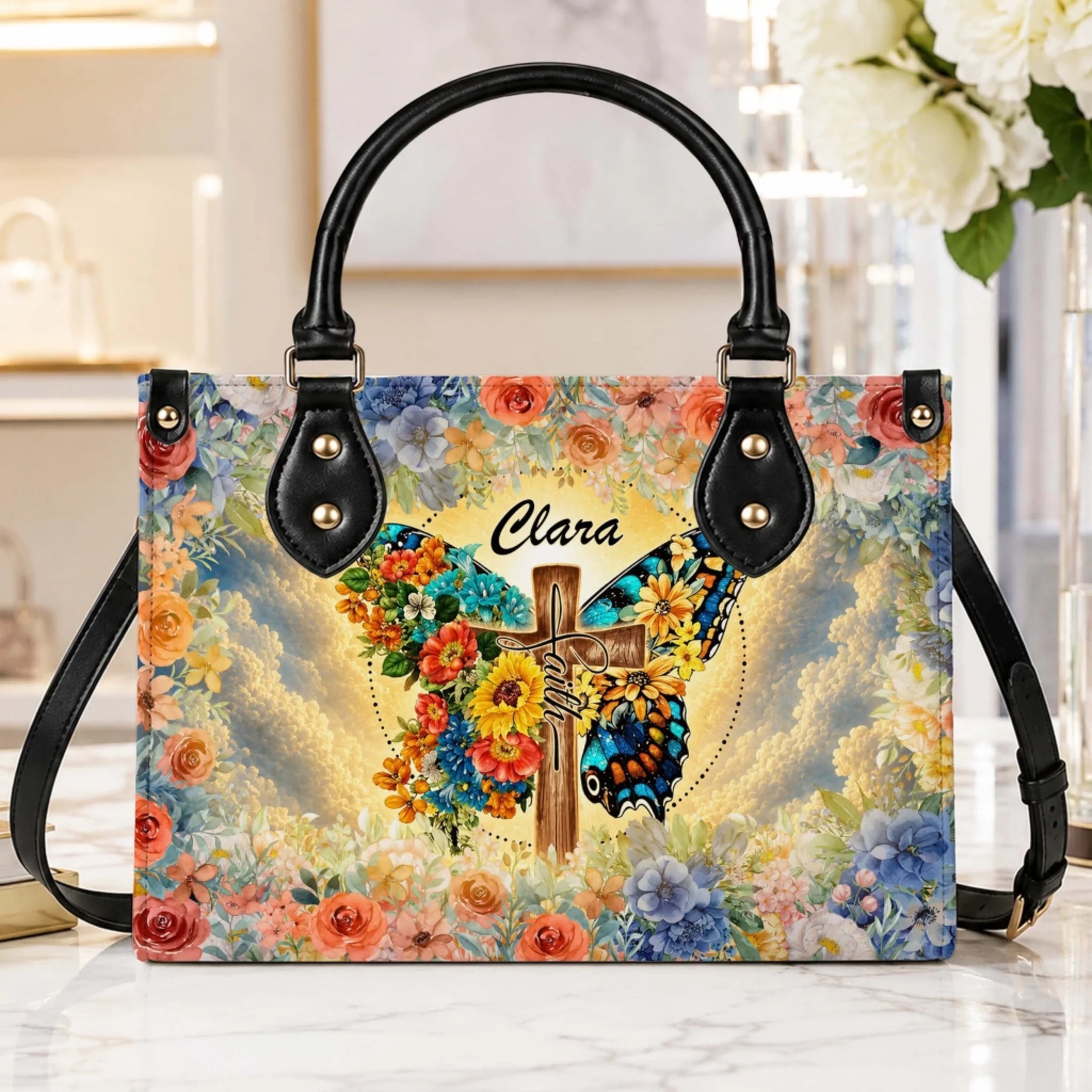 Personalized handbag with a butterfly and cross design, featuring floral accents and the custom name Clara, perfect as a sympathy gift.