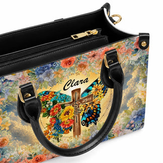Customized handbag for Clara featuring a butterfly and cross floral design with faith written on the front.