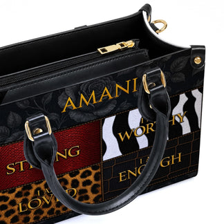 Close up view of a custom Amani handbag showing detailed textures and inspirational text in a sophisticated design.