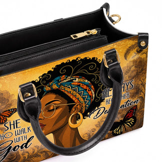 Close up view of a fashion handbag interior with a high quality zipper and artistic religious theme exterior.