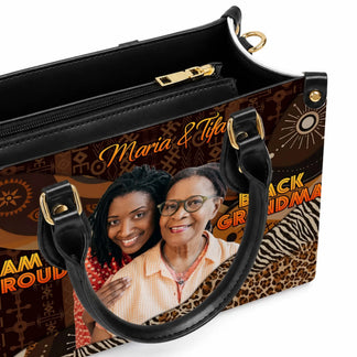 Detailed view of a black tote bag featuring a custom family portrait photo and the text Maria Tifa Black Grandma.