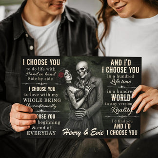 Couple holding a custom skeleton couple wall art canvas with the romantic quote I choose you and custom names Henry and Evie.