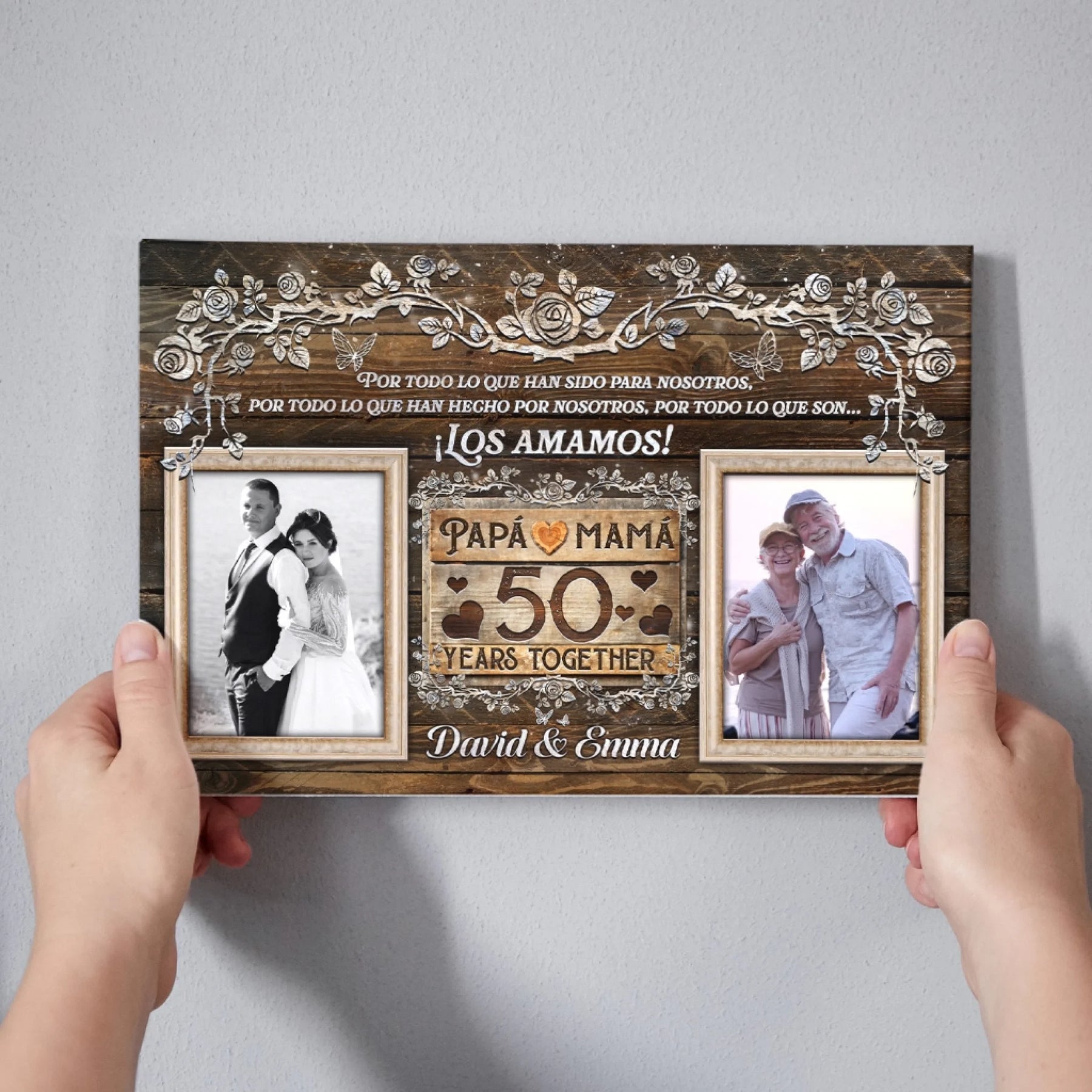 Hands holding a custom 50th wedding anniversary canvas featuring rustic floral art and space for two family photos.