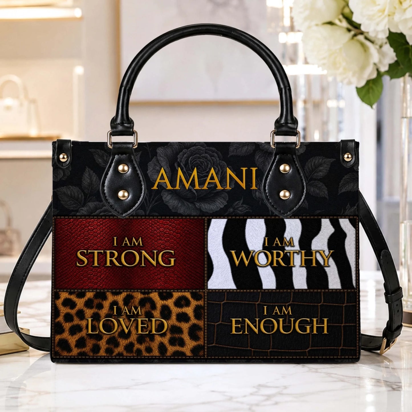 Custom Amani handbag with black floral details and inspirational text affirmations on a textured animal print pattern.