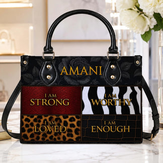 Custom Amani handbag with black floral details and inspirational text affirmations on a textured animal print pattern.