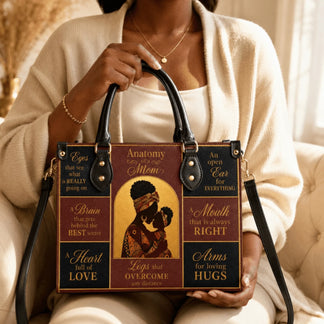 Detailed view of an Anatomy of a Mom handbag featuring a decorative mother and baby silhouette and heartfelt quotes.