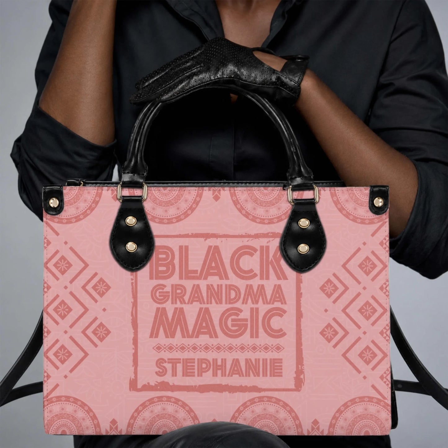 Personalized Black Grandma Magic Stephanie tote bag held by a person wearing black leather gloves