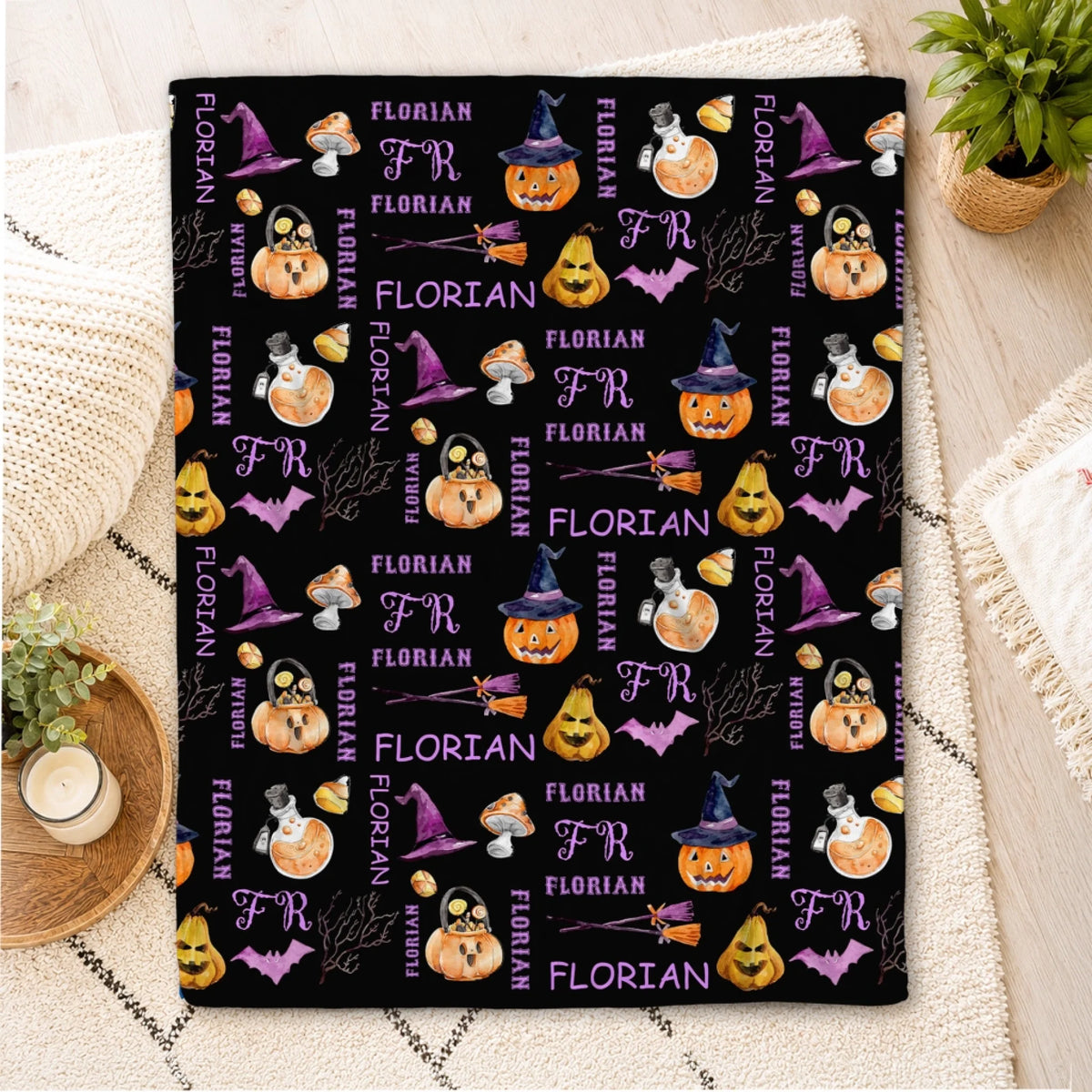 Custom black Halloween fleece blanket patterned with pumpkins, witch hats, and the name Florian for a festive gift.