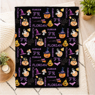 Custom black Halloween fleece blanket patterned with pumpkins, witch hats, and the name Florian for a festive gift.