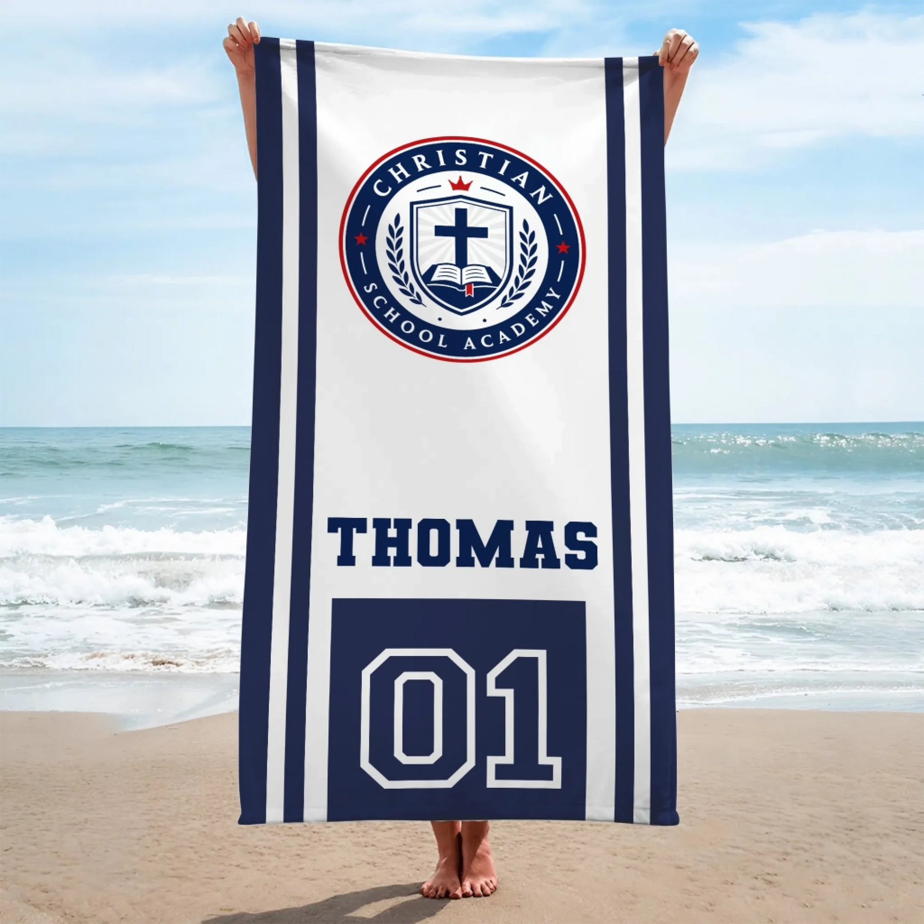 A vertical beach towel displaying the Christian School Academy logo, custom name Thomas, and jersey number 01.