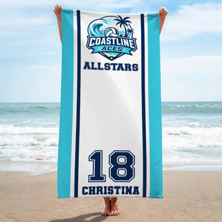 Person holding a custom Coastline Aces Allstars volleyball beach towel with name and number 18 at the beach.