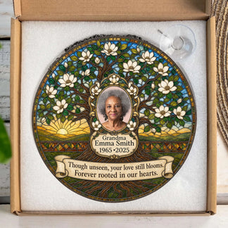 A custom commemorative tree of life suncatcher displayed in a gift box with a sympathy quote to honor a loved one's memory.