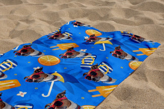 A personalized beach towel displaying a repeat pattern of a dog wearing sunglasses, perfect for summer vacations.