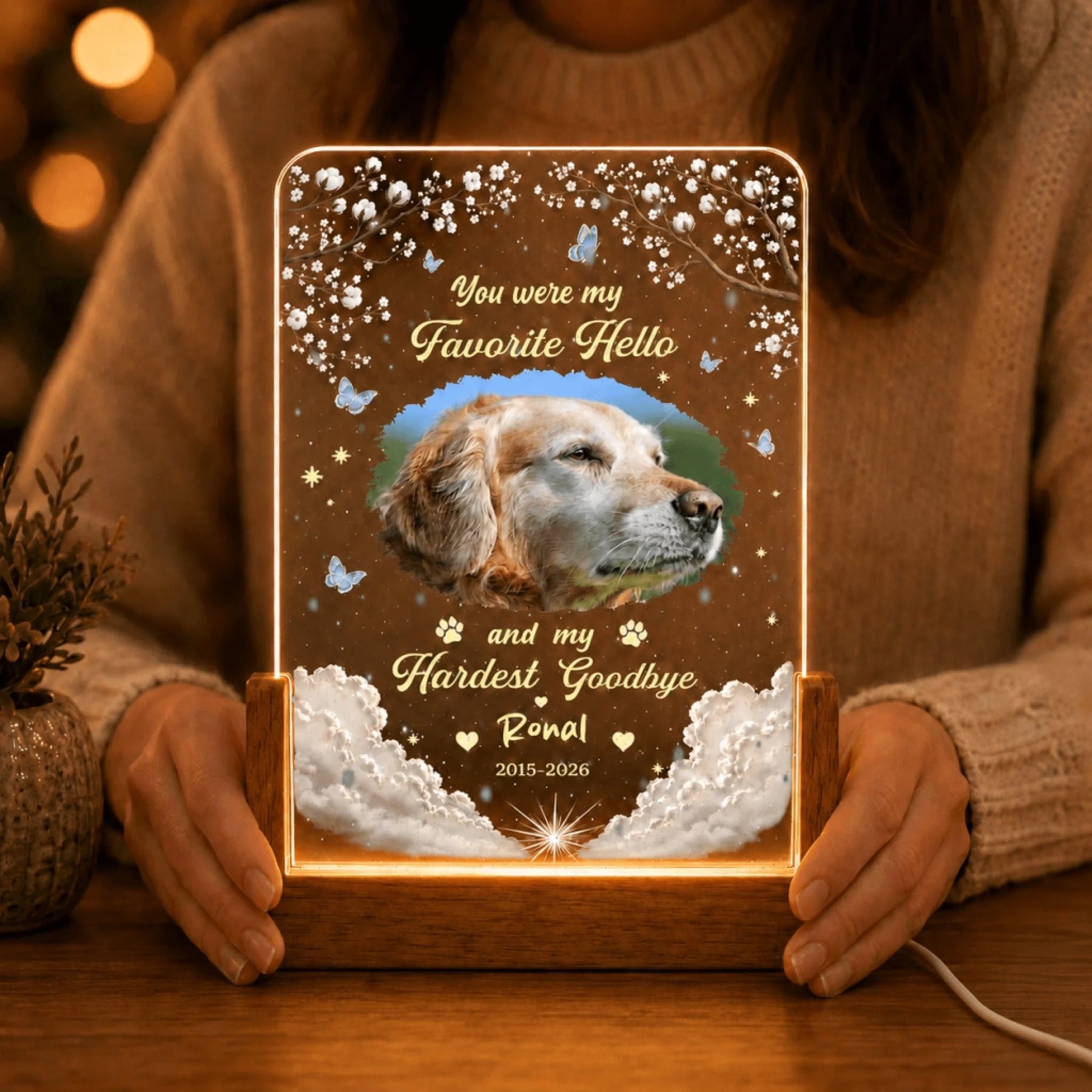 Person holding a personalized dog memorial LED night light with custom photo, name, and dates as a sympathy gift.